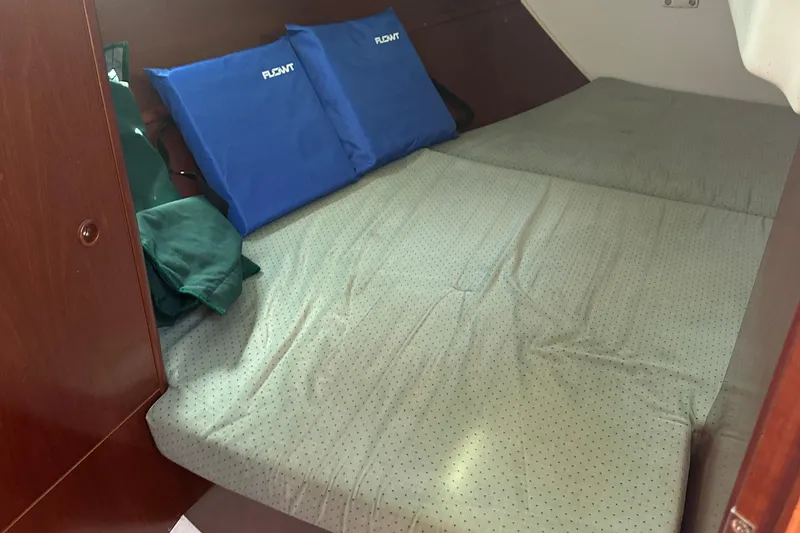 Slide: The Image of Cozy cabin bed in 2004 Beneteau 361 sailboat with blue cushions. - 22