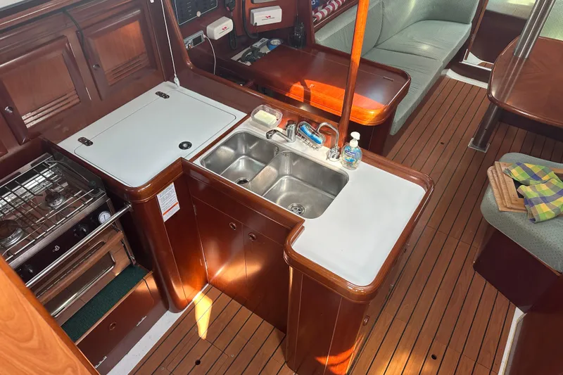 Slide: The Image of Interior of 2004 Beneteau 361 yacht with kitchen and seating area. - 24