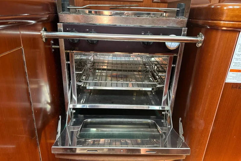 Slide: The Image of Stainless steel oven in 2004 Beneteau 361 yacht galley, featuring wooden cabinetry. - 26