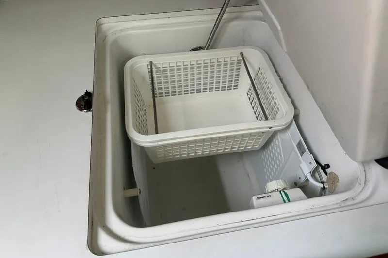 Slide: The Image of Storage compartment with basket in 2004 Beneteau 361 yacht. - 29