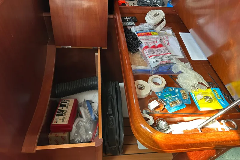 Slide: The Image of Storage compartment on a 2004 Beneteau 361 sailboat with various tools and supplies. - 32
