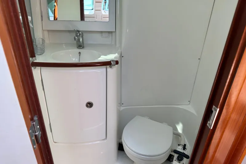 Slide: The Image of 2004 Beneteau 361 yacht bathroom with sink, mirror, and toilet. - 33