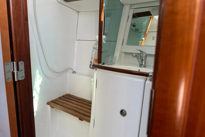 Slide: The Image of Bathroom interior of 2004 Beneteau 361 yacht with wooden accents and mirror. - 34