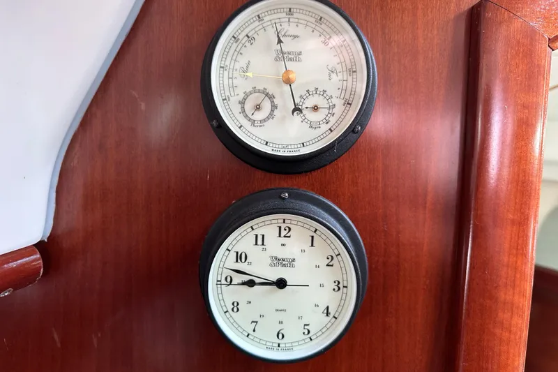 Slide: The Image of Barometer and clock on 2004 Beneteau 361 yacht's wooden interior panel. - 35