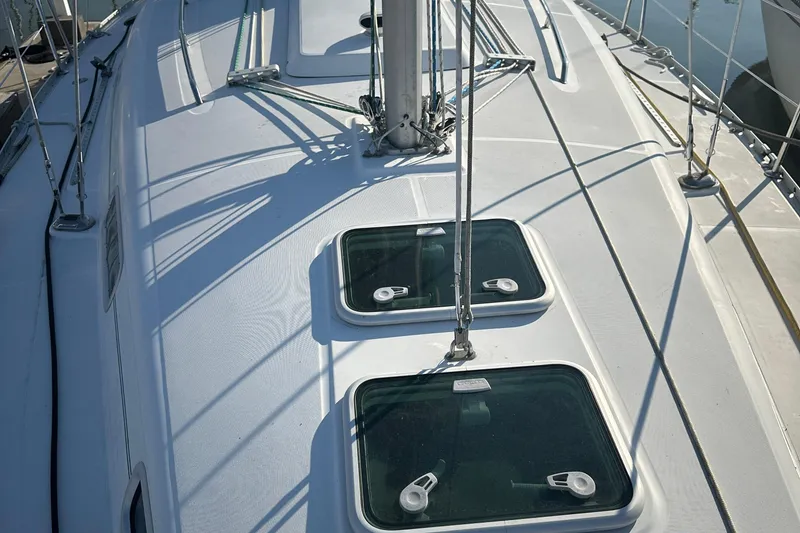 Slide: The Image of Deck view of a 2004 Beneteau 361 sailboat with hatches and rigging. - 4