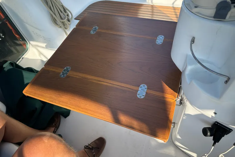 Slide: The Image of Wooden cockpit table on a 2004 Beneteau 361 sailboat, featuring metal hinges. - 6