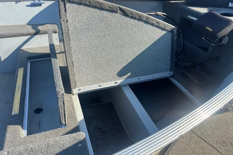 Slide: The Image of 2013 Lund 1600 Fury Tiller boat interior with open storage compartments. - 7