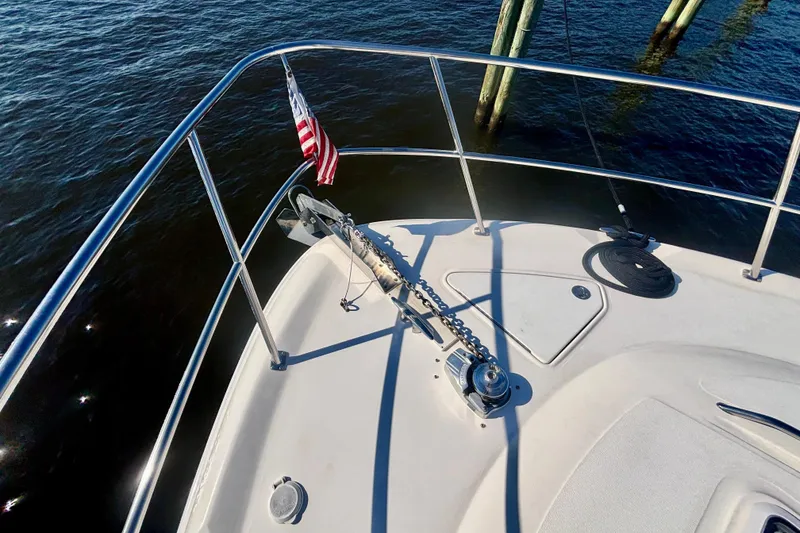 Slide: The Image of Bow of 2003 Sea Ray 480 Sedan Bridge with anchor and American flag. - 12