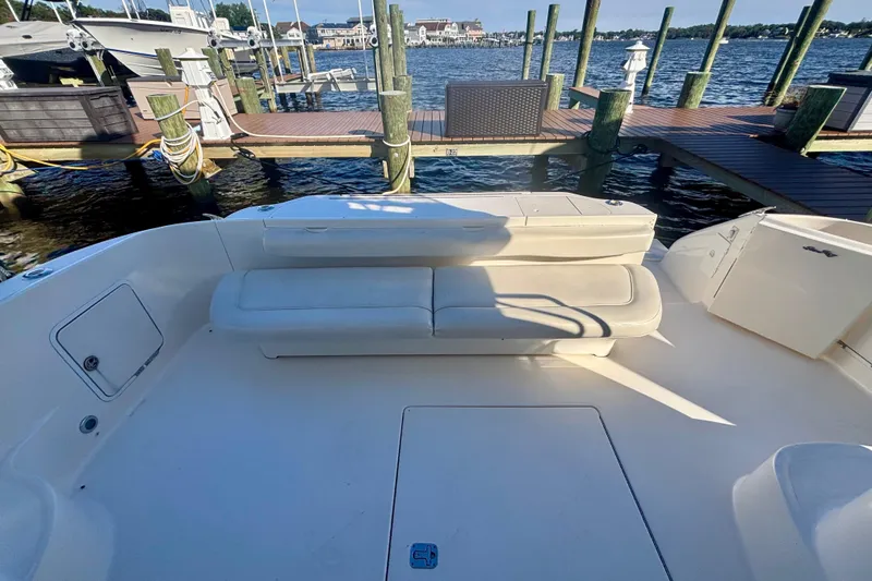 Slide: The Image of 2003 Sea Ray 480 Sedan Bridge yacht with spacious deck and seating at marina. - 13
