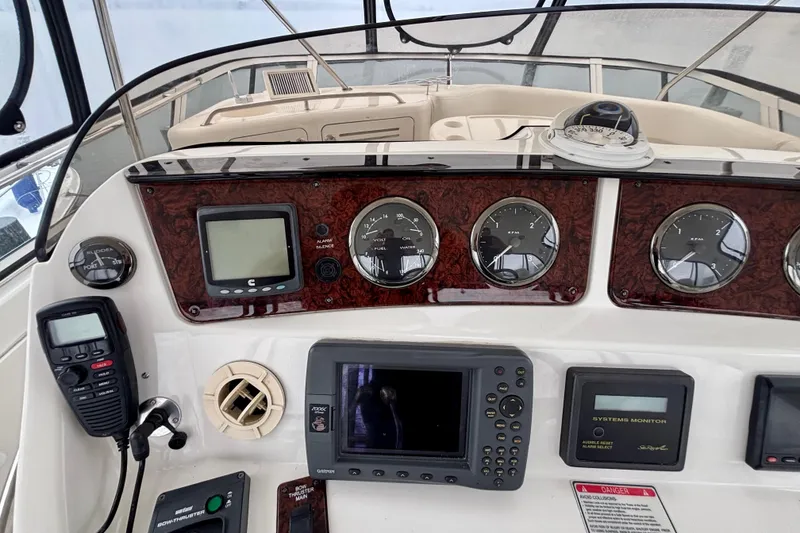 Slide: The Image of Control panel of a 2003 Sea Ray 480 Sedan Bridge with navigation and communication equipment. - 15