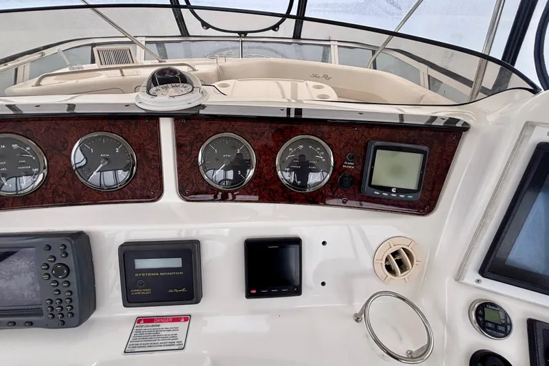 Slide: The Image of 2003 Sea Ray 480 Sedan Bridge dashboard with gauges and navigation equipment. - 16