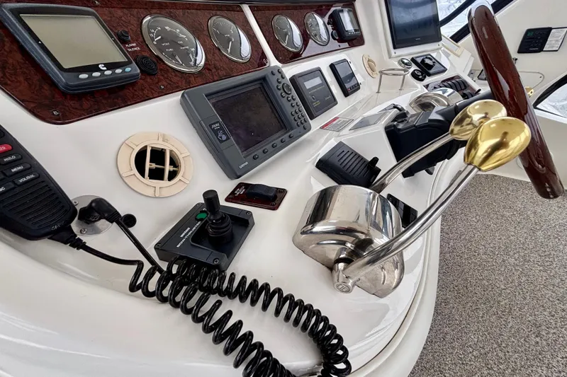 Slide: The Image of Control panel of a 2003 Sea Ray 480 Sedan Bridge yacht with navigation instruments. - 17