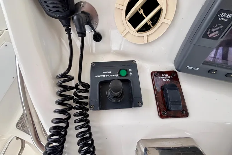 Slide: The Image of Control panel of a 2003 Sea Ray 480 Sedan Bridge with bow thruster controls. - 18