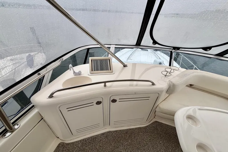 Slide: The Image of 2003 Sea Ray 480 Sedan Bridge interior with sink and seating area. - 28