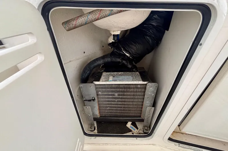 Slide: The Image of 2003 Sea Ray 480 Sedan Bridge engine compartment with visible components and hoses. - 30