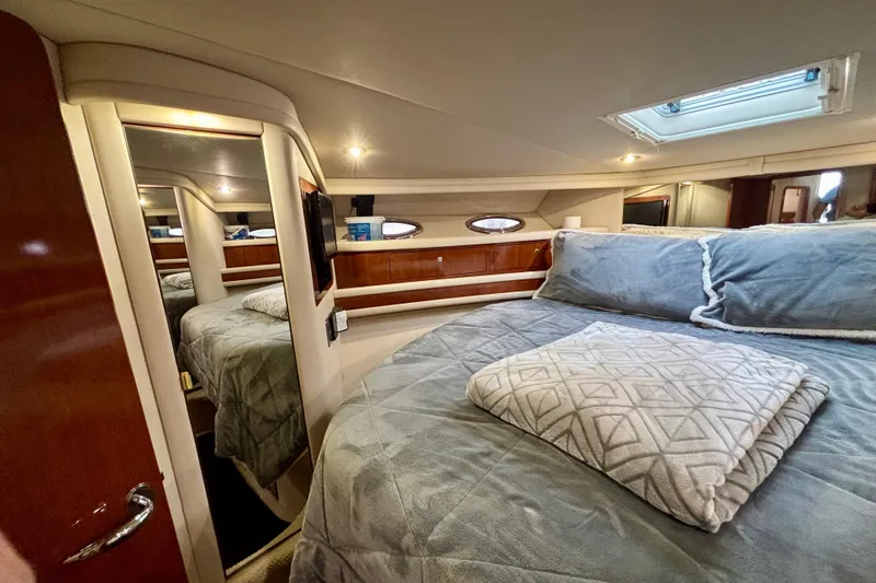 Slide: The Image of Luxurious 2003 Sea Ray 480 Sedan Bridge bedroom with cozy bedding and elegant wood finishes. - 32