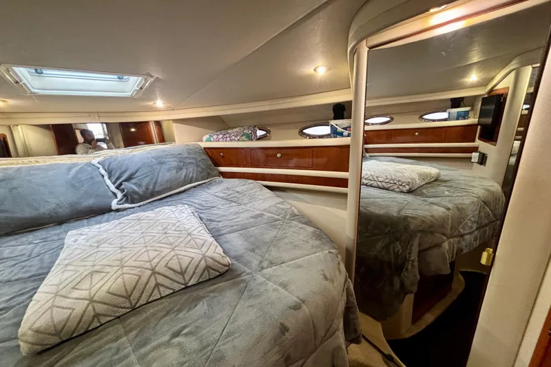 Slide: The Image of Luxurious bedroom interior of 2003 Sea Ray 480 Sedan Bridge yacht with plush bedding. - 33