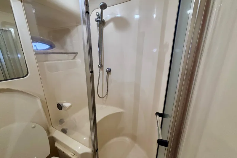 Slide: The Image of 2003 Sea Ray 480 Sedan Bridge bathroom with shower and toilet. - 44