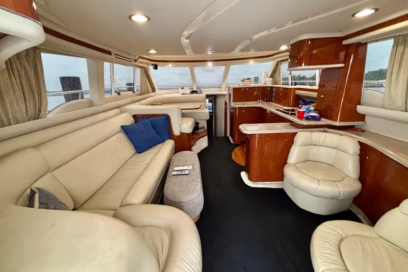 Slide: The Image of Luxurious interior of a 2003 Sea Ray 480 Sedan Bridge yacht with leather seating and wood finishes. - 46