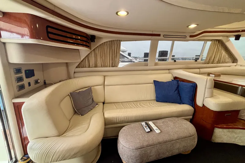 Slide: The Image of Luxurious interior of a 2003 Sea Ray 480 Sedan Bridge yacht with plush seating. - 48