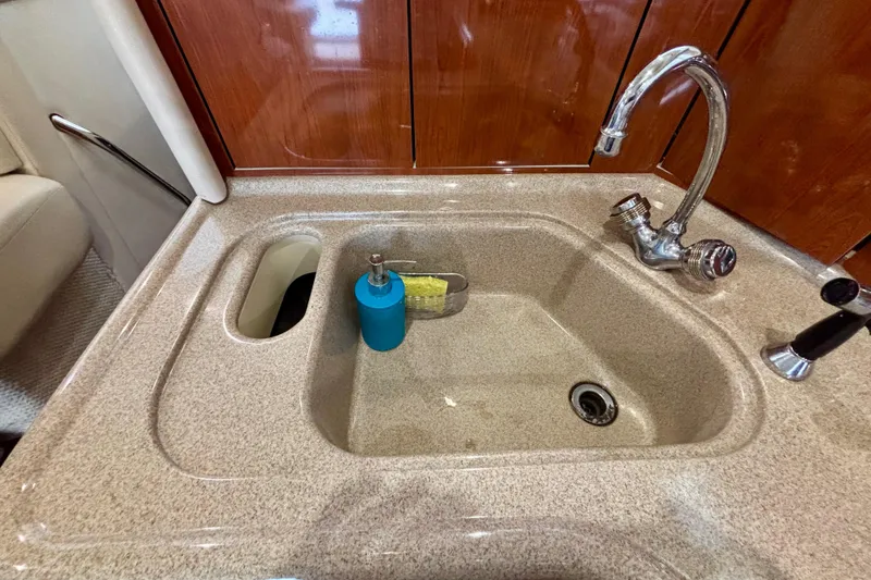 Slide: The Image of Kitchen sink area on a 2003 Sea Ray 480 Sedan Bridge yacht. - 53