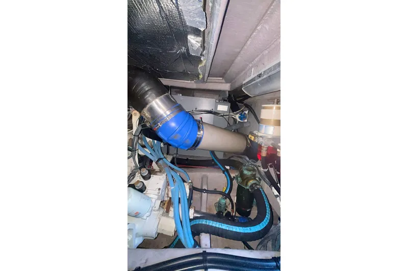 Slide: The Image of Engine room of 2003 Sea Ray 480 Sedan Bridge with visible hoses and components. - 55