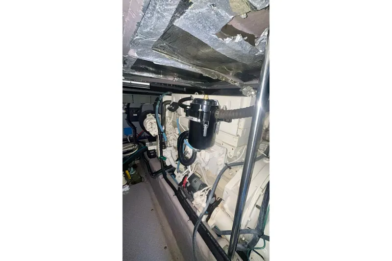 Slide: The Image of Engine room of 2003 Sea Ray 480 Sedan Bridge with visible components and wiring. - 56
