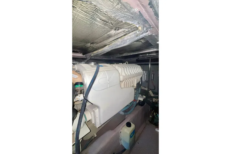 Slide: The Image of Engine room of 2003 Sea Ray 480 Sedan Bridge with visible components and insulation. - 57