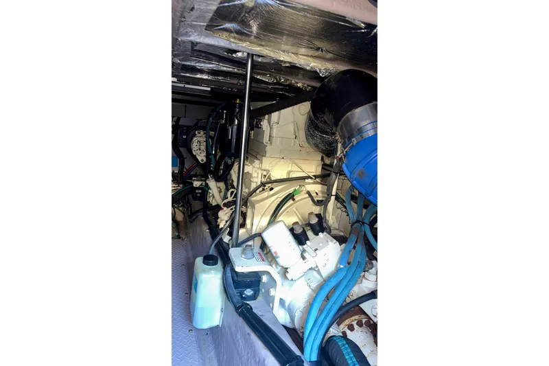 Slide: The Image of Engine room of 2003 Sea Ray 480 Sedan Bridge, showcasing mechanical components and wiring. - 58