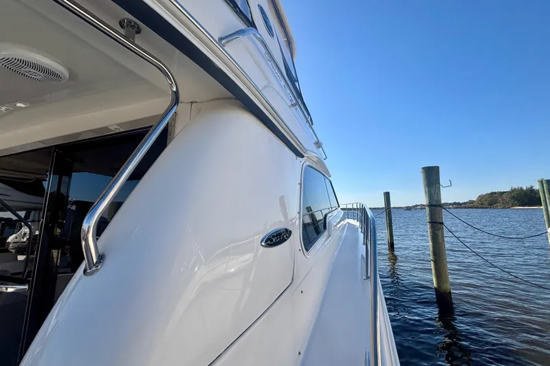Slide: The Image of 2003 Sea Ray 480 Sedan Bridge yacht docked by calm waters. - 7