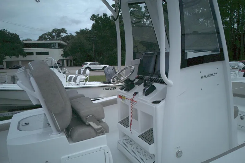 Slide: The Image of 2025 Sea Hunt BX 25 FS boat interior with steering console and seating. - 5