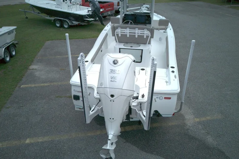 Slide: The Image of 2025 Sea Hunt BX 25 FS boat with powerful outboard motor, parked on a trailer. - 9