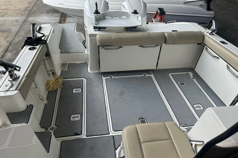 Slide: The Image of 2020 Pursuit OS 325 Offshore boat interior with seating and storage compartments. - 14