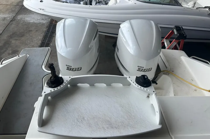 Slide: The Image of 2020 Pursuit OS 325 Offshore boat with dual Yamaha 300 engines in a dock setting. - 15