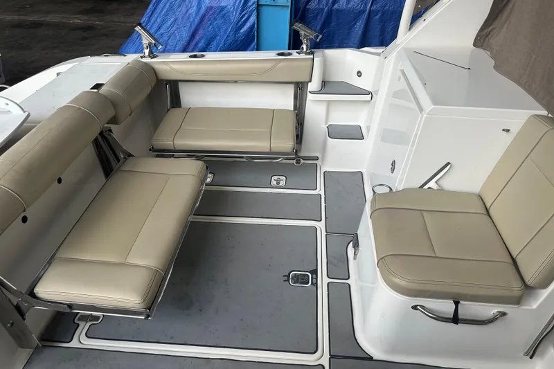 Slide: The Image of 2020 Pursuit OS 325 Offshore boat interior with beige seating and gray flooring. - 17