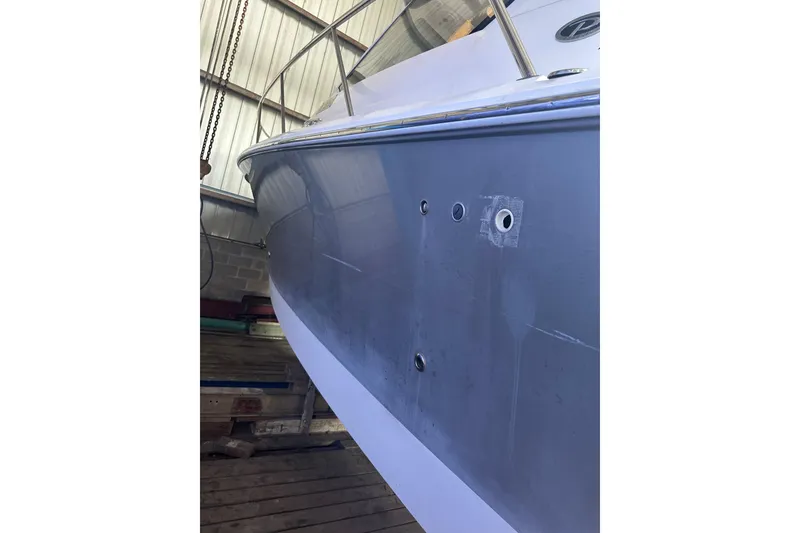 Slide: The Image of 2020 Pursuit OS 325 Offshore boat hull in a storage facility. - 25