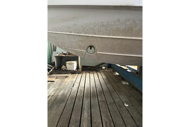 Slide: The Image of 2020 Pursuit OS 325 Offshore boat hull on wooden dock, showing underside details. - 26