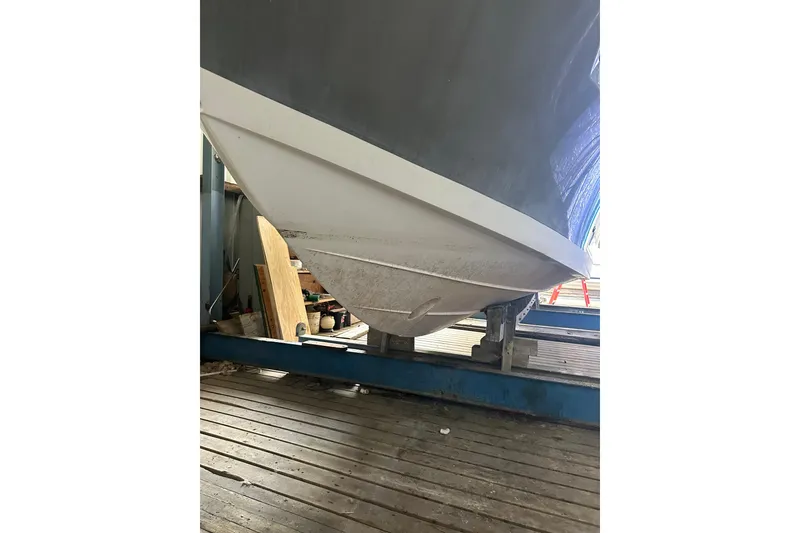 Slide: The Image of 2020 Pursuit OS 325 Offshore boat hull on a wooden dock. - 27