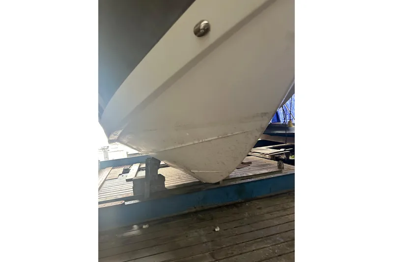 Slide: The Image of 2020 Pursuit OS 325 Offshore boat hull on a trailer. - 28