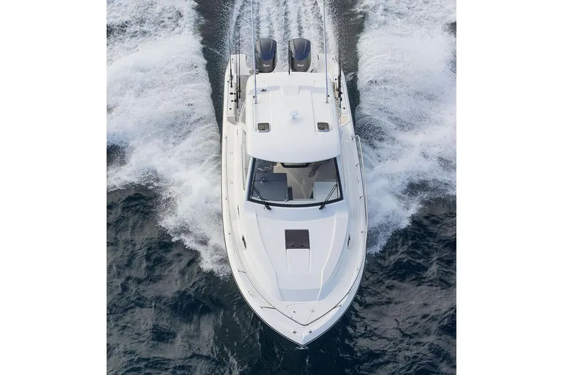 Slide: The Image of Manufacturer Provided Image: 2020 Pursuit OS 325 Offshore boat cruising on water, aerial view. - 3