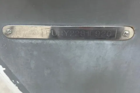 Slide: The Image of 2020 Pursuit OS 325 Offshore metal identification plate on a boat hull. - 6
