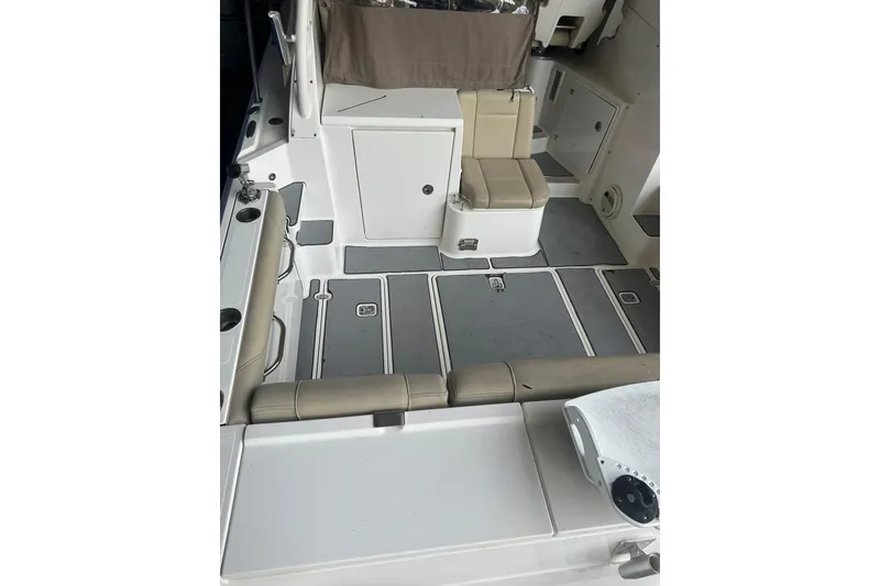 Slide: The Image of 2020 Pursuit OS 325 Offshore boat interior with seating and storage compartments. - 7
