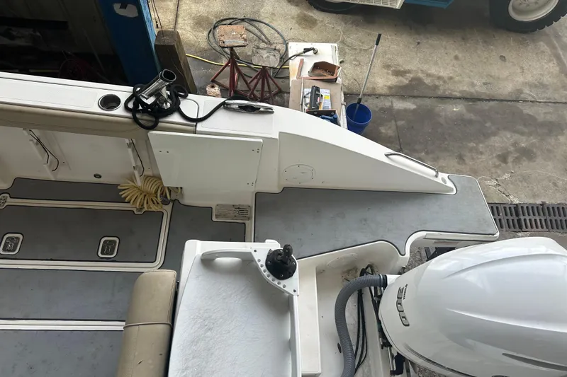 Slide: The Image of 2020 Pursuit OS 325 Offshore boat deck with equipment and outboard motor. - 9