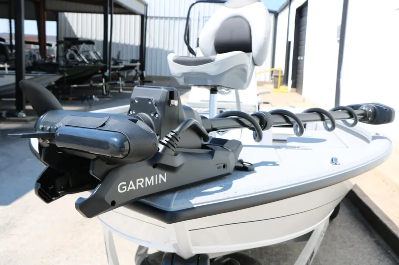 Slide: The Image of 2025 Vexus ACX 2000 boat with Garmin trolling motor, docked outdoors. - 11