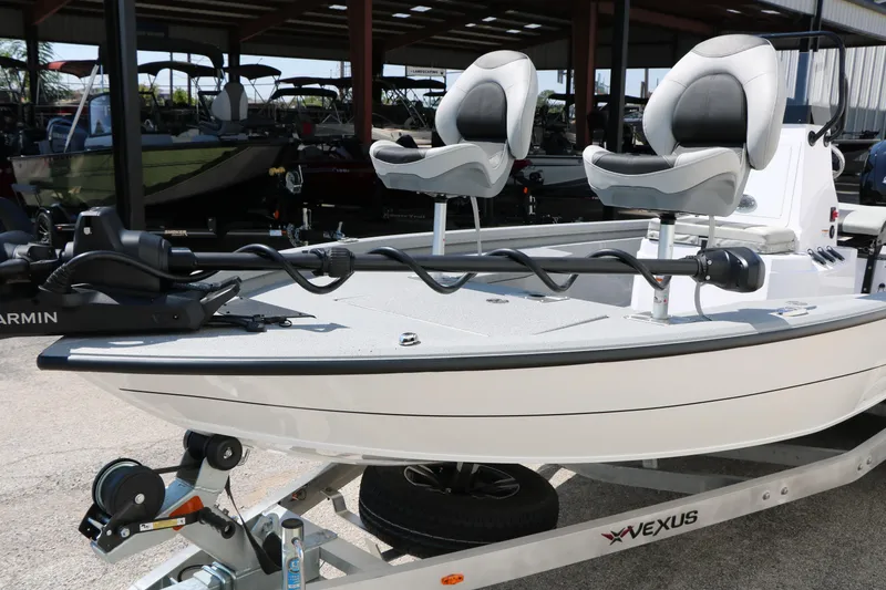 Slide: The Image of 2025 Vexus ACX 2000 boat with dual seats on a trailer in a showroom. - 25