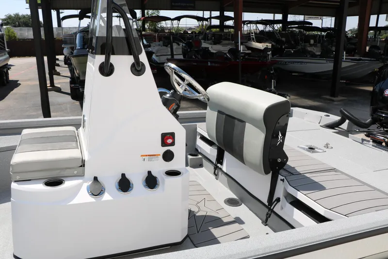 Slide: The Image of 2025 Vexus ACX 2000 boat interior with seating and control panel in a showroom. - 31