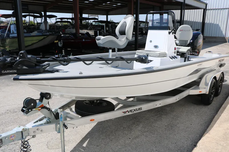 Slide: The Image of 2025 Vexus ACX 2000 boat on trailer, featuring Garmin equipment, parked in a covered area. - 6