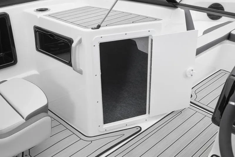 Slide: The Image of 2025 Yamaha Boats 195S interior storage compartment with open door, showcasing sleek design. - 12