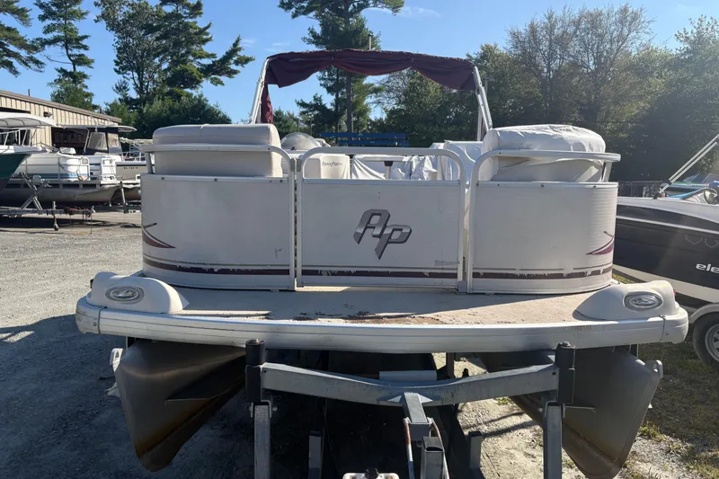 Slide: The Image of 2003 Aqua Patio 200RE pontoon boat on trailer in outdoor storage area. - 8