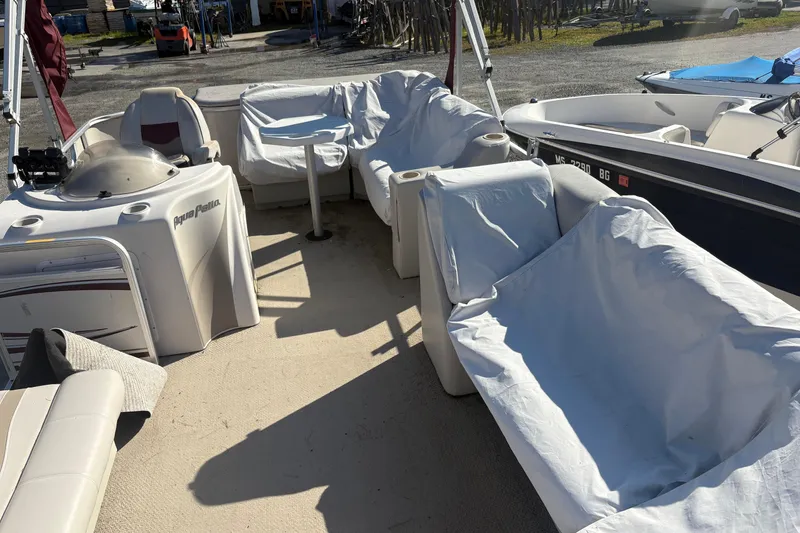 Slide: The Image of 2003 Aqua Patio 200RE pontoon boat interior with covered seating and helm. - 9